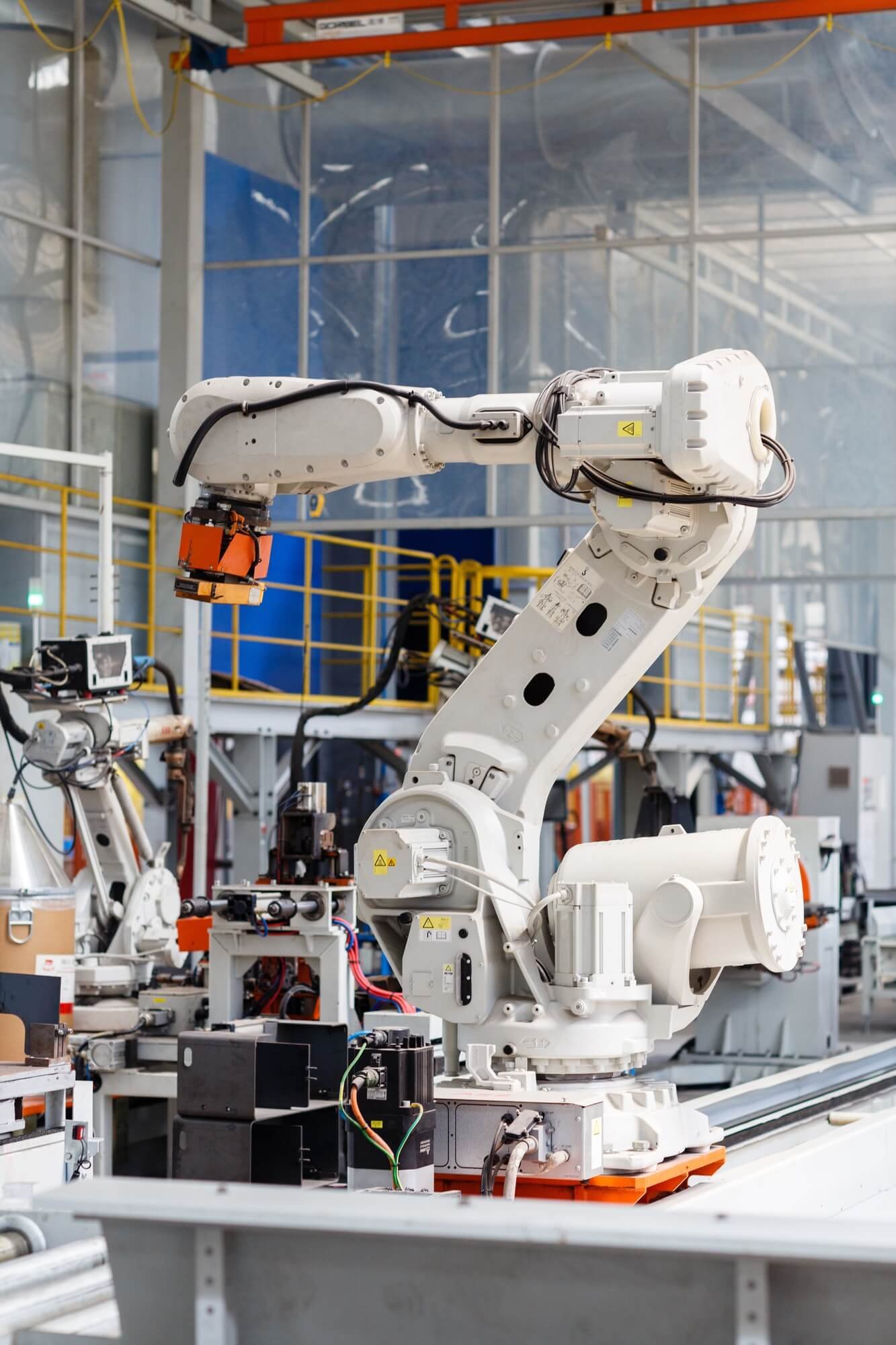 Industrial robot performing laser cutting in a modern factory