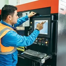 Operator loading a job at a laser workstation