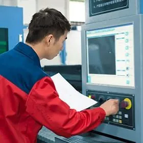 Technician setting cutting parameters on a control panel