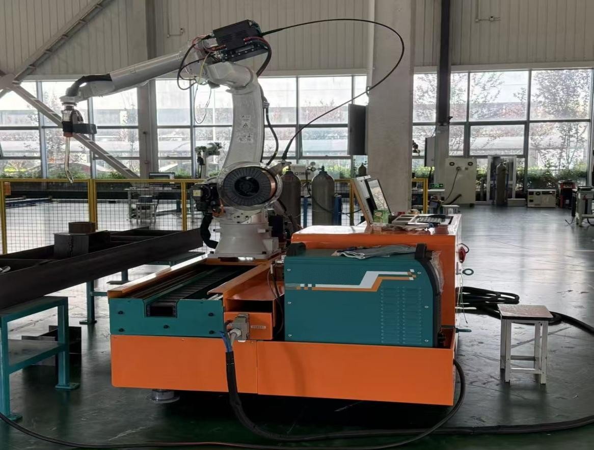 Mobile crawler welding robot working in a steel structure workshop